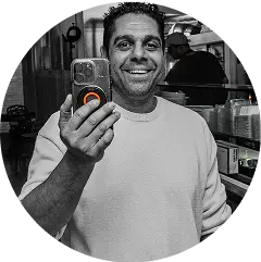 arafed man taking a selfie in a kitchen with a phone
