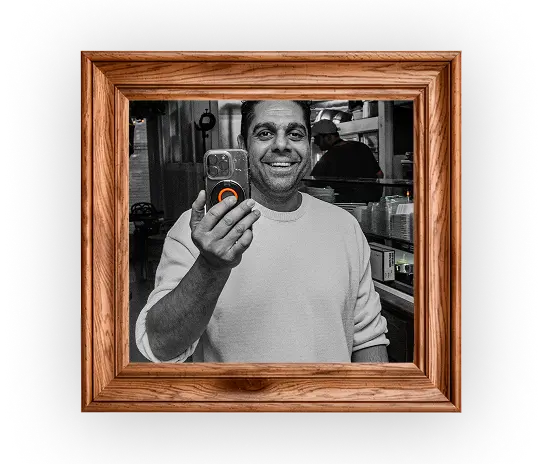 arafed picture of a man holding a cell phone in a picture frame