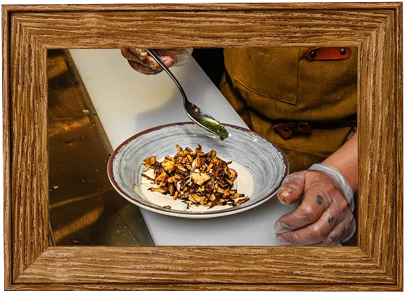 someone is preparing food in a bowl with a spoon in a picture frame