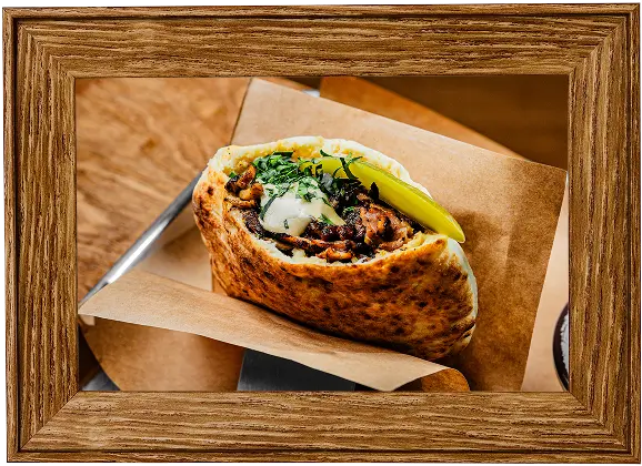 there is a picture of a burrito with a pickle on top